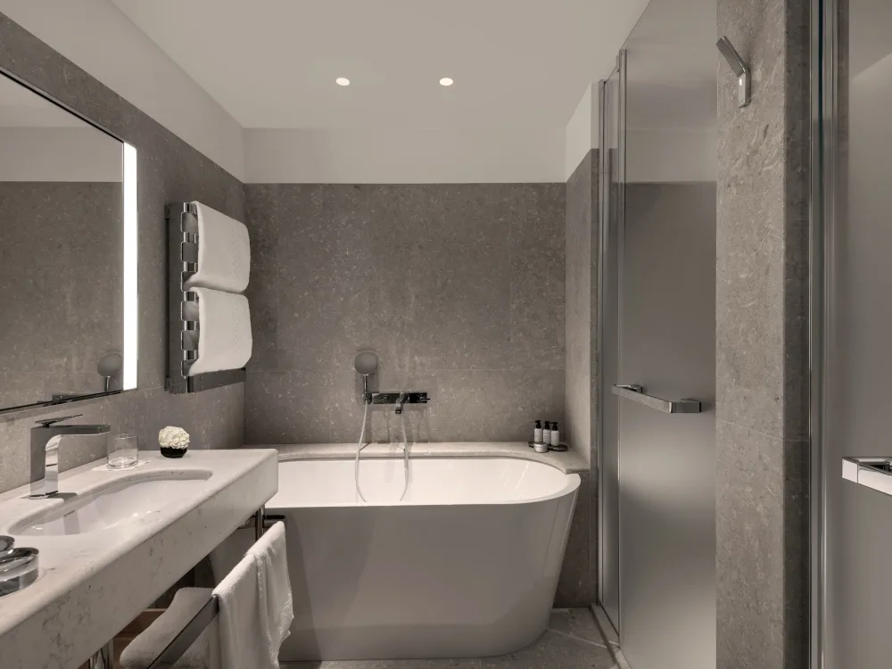 Serlas Room — grey stone bathroom with freestanding bathtub and walk-in shower
